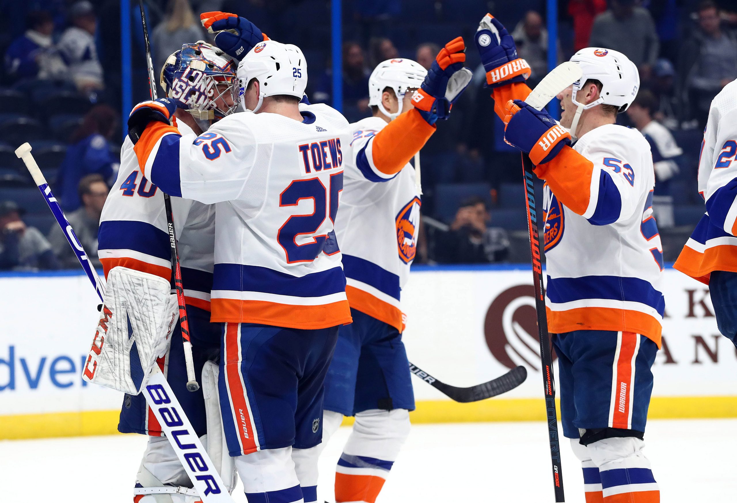 Dec 9, 2019; Tampa, FL, USA; New York Islanders goaltender Semyon Varlamov (40), defenseman Devon Toews (25), center Casey Cizikas (53) and teammates celebrate as they beat the Tampa Bay Lightning during the third period at Amalie Arena. Mandatory Credit: Kim Klement-USA TODAY Sports