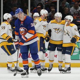 Dec 17, 2019; Uniondale, NY, USA; Nashville Predators defenseman Mattias Ekholm (14) celebrates his goal against the New York Islanders with teammates in front of Islanders left wing Ross Johnston (32) during the second period at Nassau Veterans Memorial Coliseum. Mandatory Credit: Brad Penner-USA TODAY Sports
