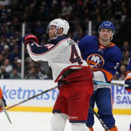 Dec 23, 2019; Uniondale, New York, USA; Columbus Blue Jackets defenseman Vladislav Gavrikov (44) reacts after scoring the game winning goal against New York Islanders defenseman Devon Toews (25) and defenseman Adam Pelech (3) and left wing Anders Lee (27) during the third period at Nassau Veterans Memorial Coliseum. Mandatory Credit: Brad Penner-USA TODAY Sports