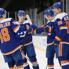 Feb 23, 2020; Uniondale, New York, USA; New York Islanders defenseman Devon Toews (25) celebrates his goal against the San Jose Sharks with teammates during the second period at Nassau Veterans Memorial Coliseum. Mandatory Credit: Brad Penner-USA TODAY Sports