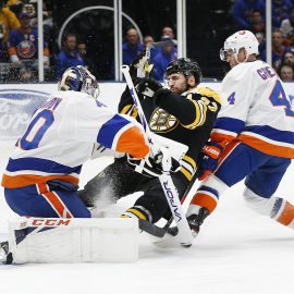 Feb 29, 2020; Uniondale, New York, USA; Boston Bruins center Patrice Bergeron (37) collides with New York Islanders goaltender Semyon Varlamov (40) during the first period at Nassau Veterans Memorial Coliseum. Mandatory Credit: Andy Marlin-USA TODAY Sports