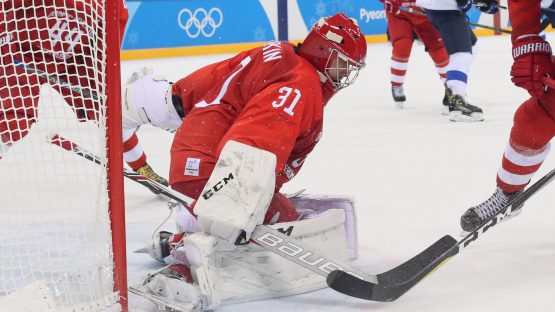 Feb 16, 2018; Gangneung, South Korea; Olympic Athlete of Russia defenseman Vladislav Gavrikov (4) and Slovenia forward Miha Verlic (91) battle for the puck in front of Olympic Athlete of Russia goalkeeper Ilya Sorokin (31) during the third period at the Pyeongchang 2018 Olympic Winter Games at Gangneung Hockey Centre. Mandatory Credit: David E. Klutho-USA TODAY Sports