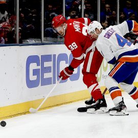 Feb 21, 2020; Uniondale, New York, USA; Detroit Red Wings right wing Anthony Mantha (39) and New York Islanders defenseman Andy Greene (4) battle for a loose puck during the first period at Nassau Veterans Memorial Coliseum. Mandatory Credit: Andy Marlin-USA TODAY Sports