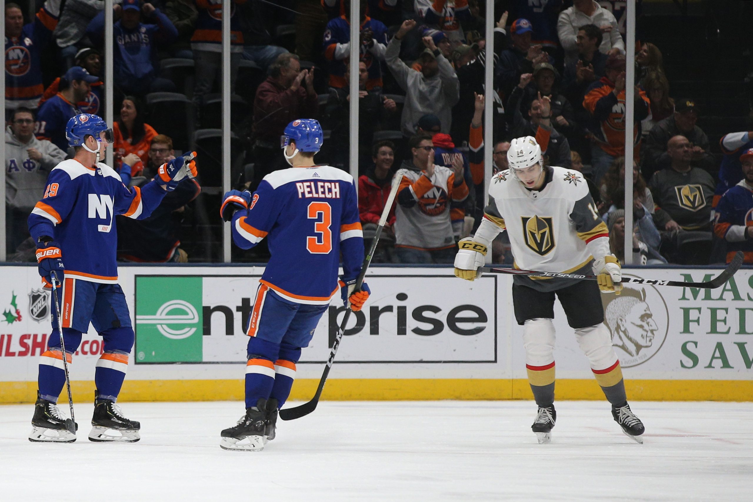 Dec 5, 2019; Uniondale, NY, USA; New York Islanders center Brock Nelson (29) celebrates with defenseman Adam Pelech (3) after scoring a goal against the Vegas Golden Knights in front of Golden Knights defenseman Nicolas Hague (14) during the third period at Nassau Veterans Memorial Coliseum. Mandatory Credit: Brad Penner-USA TODAY Sports