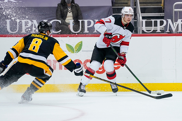 new-jersey-devils-center-yegor-sharangovich-passes-the-puck-while-picture-id1232457452