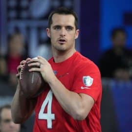 Derek Carr holds a football.