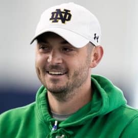 Tommy Rees smiles with a Notre Dame hat on.