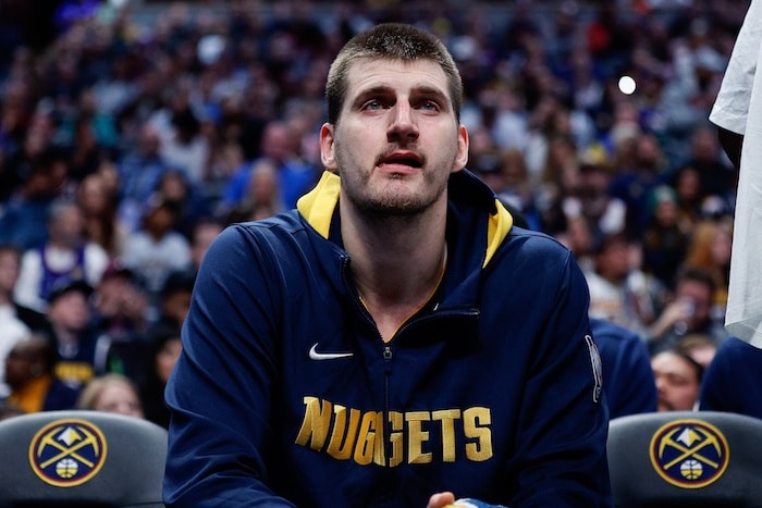 Denver Nuggets center Nikola Jokic sits and stares.