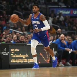 LA Clippers forward Paul George dribbles a ball.