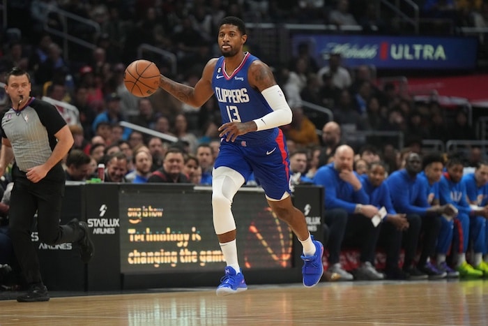 LA Clippers forward Paul George dribbles a ball.