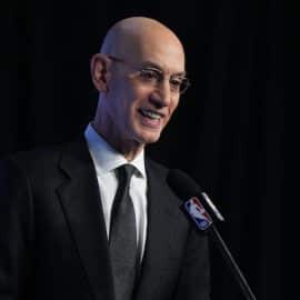 NBA commissioner Adam Silver stands at podium.