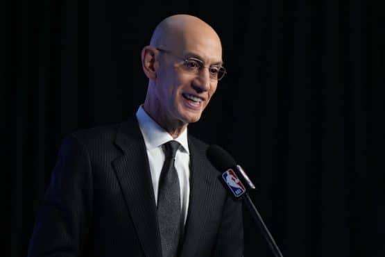NBA commissioner Adam Silver stands at podium.