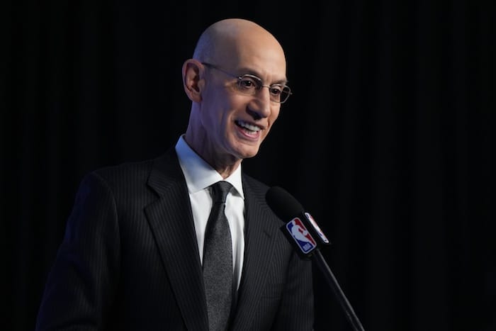 NBA commissioner Adam Silver stands at podium.