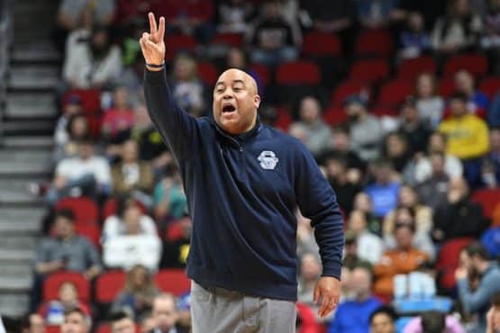Penn State Nittany Lions head coach Micah Shrewsberry holds up a 2-sign.