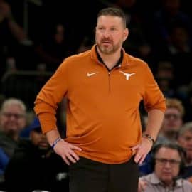 Texas Longhorns head coach Chris Beard stands with hands on hip.