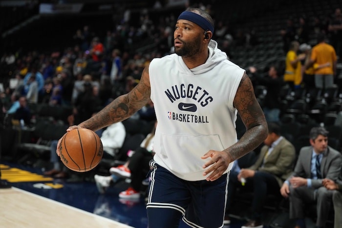Denver Nuggets center DeMarcus Cousins dribbles.