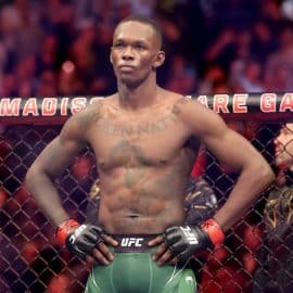 Israel Adesanya stands in the octagon.