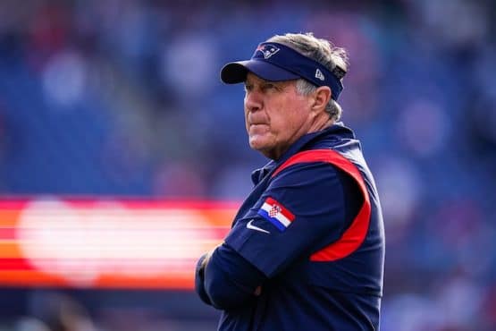 New England Patriots head coach Bill Belichick stands and stares.