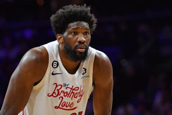 Philadelphia 76ers center Joel Embiid stands hunched over.