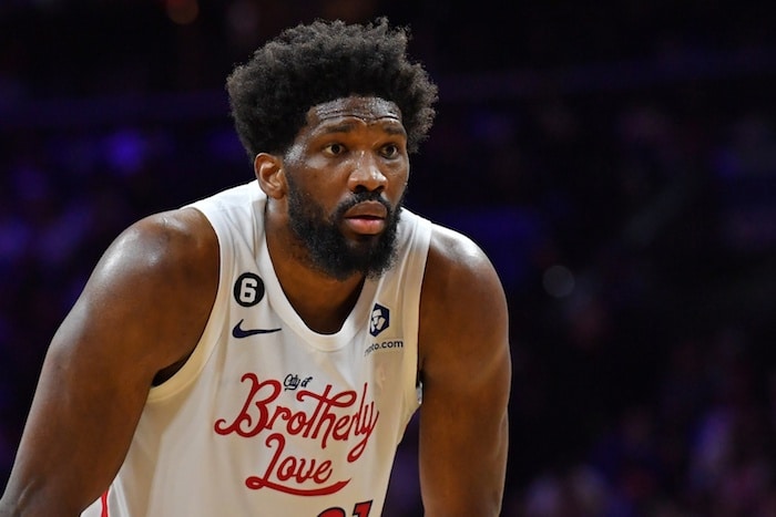 Philadelphia 76ers center Joel Embiid stands hunched over.
