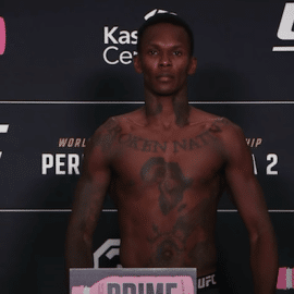 Israel Adesanya stands on scale at UFC 287.
