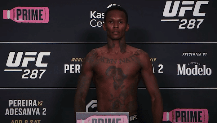 Israel Adesanya stands on scale at UFC 287.