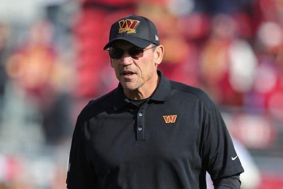 Washington Commanders head coach Ron Rivera stands.