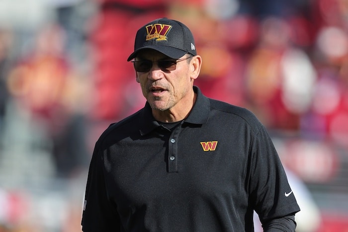 Washington Commanders head coach Ron Rivera stands.