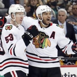 Two Blackhawks celebrate a goal.