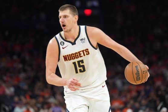 Denver Nuggets center Nikola Jokic dribbles the ball.