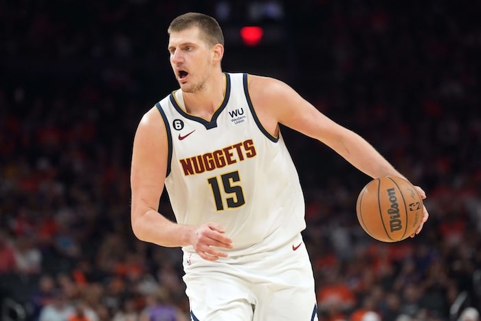 Denver Nuggets center Nikola Jokic dribbles the ball.