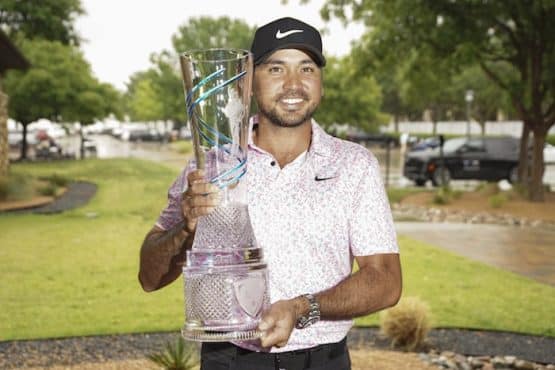 Jason Day poses with the winner's trophy.