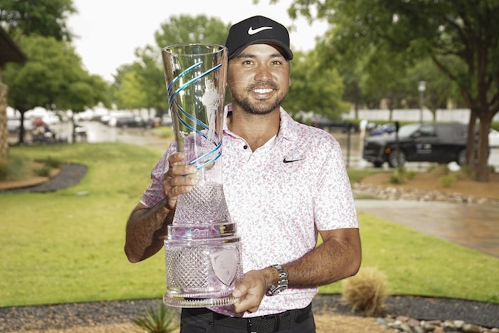 Jason Day poses with the winner's trophy.