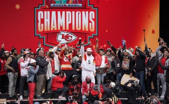 Chiefs players stand on the stage and celebrate.