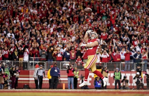 San Francisco 49ers running back Christian McCaffrey tosses the ball.
