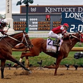Sonny Leon aboard Rich Strike wins the 148th running of the Kentucky Derby at the finish line.