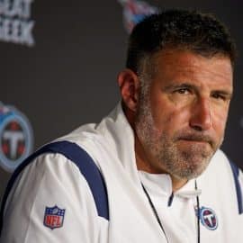 Tennessee Titans head coach Mike Vrabel stands at podium.