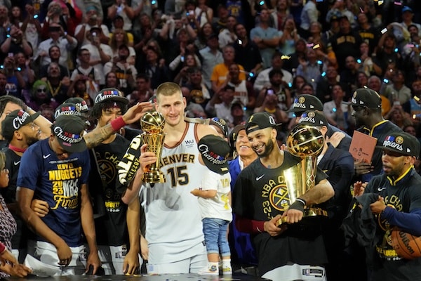 The Denver Nuggets celebrate after center Nikola Jokic