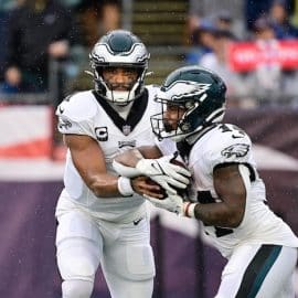 Philadelphia Eagles quarterback Jalen Hurts (1) hands the ball to running back Kenneth Gainwell
