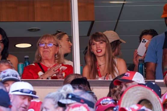 Taylor Swift reacts while sitting next to Donna Kelce