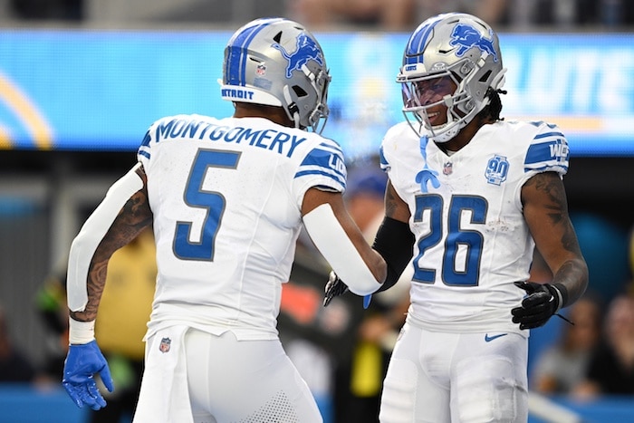 Detroit Lions running back Jahmyr Gibbs (26) celebrates with running back David Montgomery