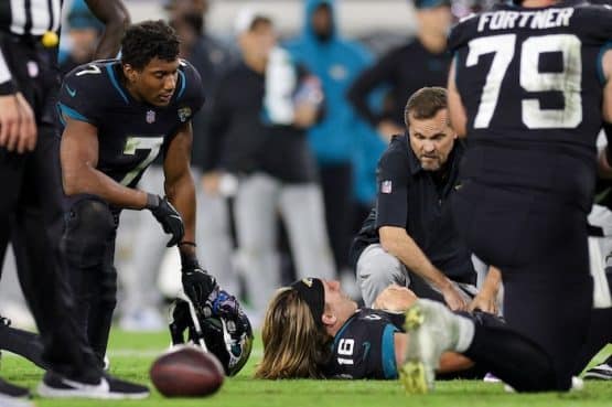 Jacksonville Jaguars quarterback Trevor Lawrence (16) reacts after an injury