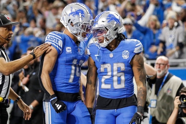 Detroit Lions running back Jahmyr Gibbs (26) celebrates a touchdown against Tampa Bay Buccaneers with wide receiver Amon-Ra St. Brown (14)