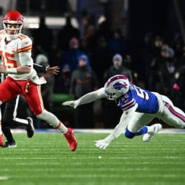 Kansas City Chiefs quarterback Patrick Mahomes (15) rushes the ball past Buffalo Bills defensive end Leonard Floyd (56)
