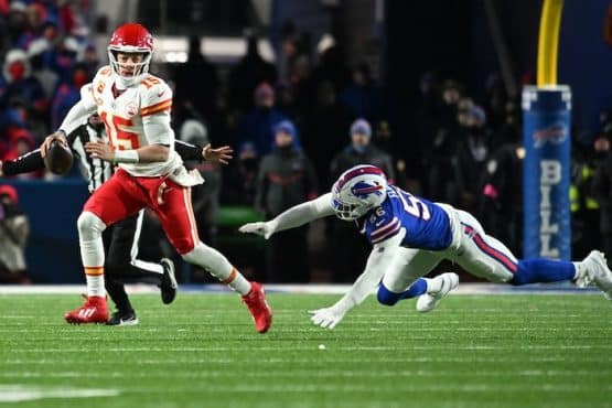 Kansas City Chiefs quarterback Patrick Mahomes (15) rushes the ball past Buffalo Bills defensive end Leonard Floyd (56)