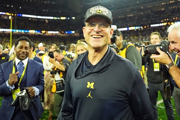 Michigan Wolverines head coach Jim Harbaugh celebrates after beating the Washington