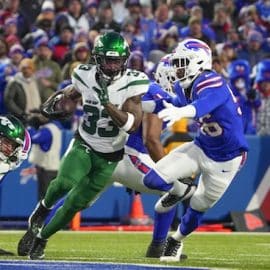 New York Jets running back Dalvin Cook (33) runs with the ball Buffalo Bills defensive end Leonard Floyd (56