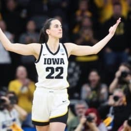 Caitlin Clark holding her hands up.