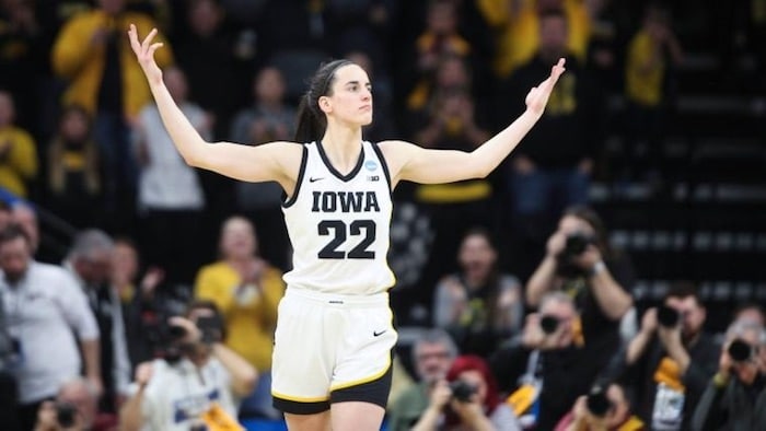 Caitlin Clark holding her hands up.