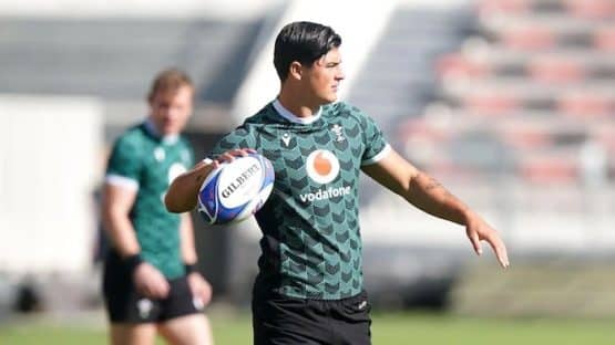 Louis Rees-Zammit throws a rugby ball.